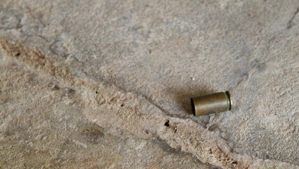 Crime evidence concept.Bullet on ground.
