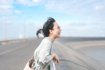 Happy smile young adult asian woman side view japanese tone photography with blue sky