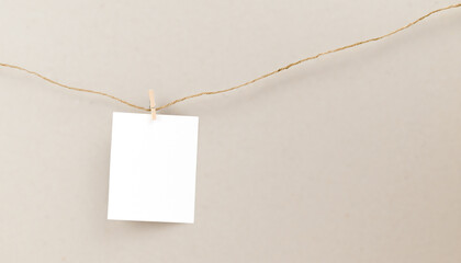Blank polaroid frame hanging on a rope with a clothespin. Retro photo frames