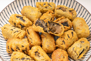 Crispy seaweed noodle rolls or Gimmari Korean deep-fried seaweed rolls, Korean traditional snack food.