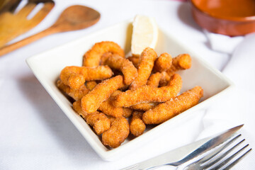 Chicken fingers. Chicken strips or chicken drumsticks are a style of fried chicken that includes only chicken, without bones or skin
