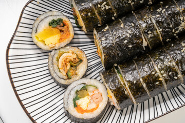 Korean Seaweed Rice Rolls or Kimbap Korean dish made from cooked rice  vegetables, meats that are rolled in seaweed, Bulgogi Kimbap and pork bbq Kimbap Korean food.