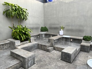 Set of coffee shop interior featuring table and chair made from concrete with modern design.