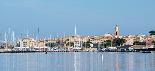 Saint Tropez view from far away with palm trees water and blue sky