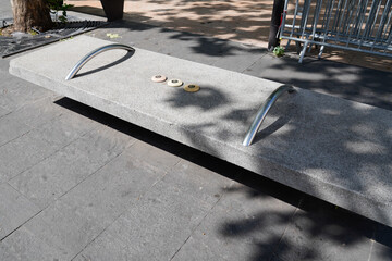 Hostile architecture defensive bench with metal armrests designed to stop people laying down...