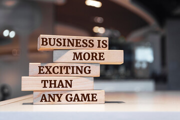 Wooden blocks with words 'Business is more exciting than any game'.