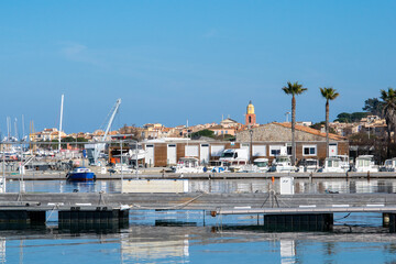 Saint Tropez view from far away with palm trees water and blue sky