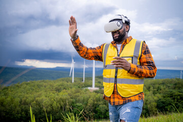 Naklejka premium Portrait of engineer African American man working with VR headset in wind turbine farm.
