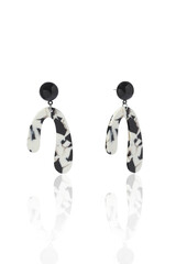 Subject shot of black, white and silver stud earrings with pendants made as a horseshoe. The abstract print earrings are isolated on the white background. Vogue accessory for ladies and girls.