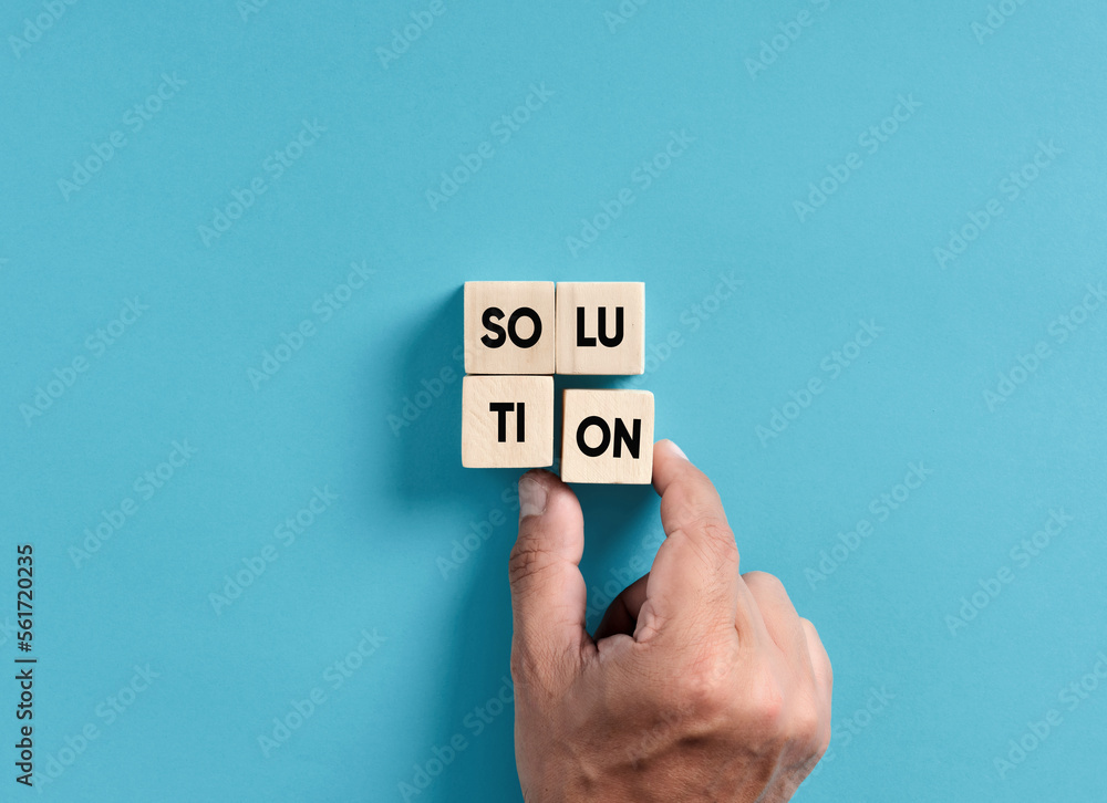 Poster finding a solution to a problem in business. male hand placing wooden blocks into a square shape to 