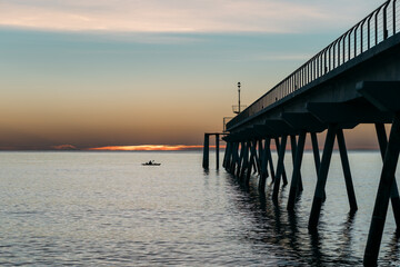 Deep into sea goes long sea pier on cruciform concrete piles, designed for mooring ships from both sides. Berth for pleasant evening walks, meeting sunset and aesthetic pleasure for eyes.
