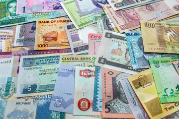 African money are scattered on the table so that it is completely covered.