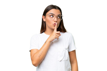 Young caucasian woman isolated on green chroma background showing a sign of silence gesture putting...