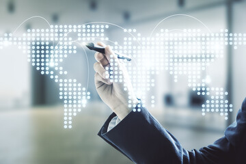 Man hand with pen working with abstract virtual world map with connections on blurred office background, international trading concept. Multiexposure