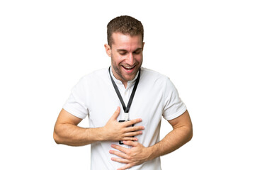 Young caucasian man with ID card isolated on green chroma background smiling a lot