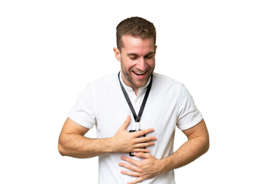 Young caucasian man with ID card isolated on green chroma background smiling a lot