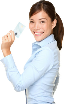 Casual business woman holding showing credit card smiling happy in blue shirt. Young female professional showing empty blank credit card sign smiling happy at camera. Isolated on transparent PNG.