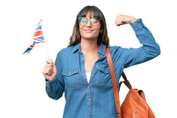 Young caucasian woman holding an United Kingdom flag over isolated background doing strong gesture