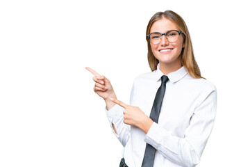 Young business caucasian woman over isolated background surprised and pointing side