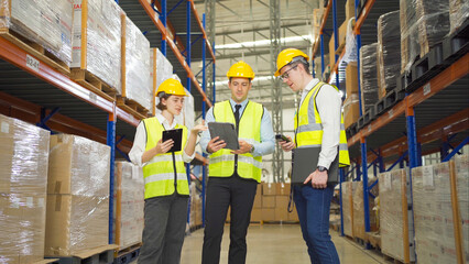 Teamwork of workers working in large warehouse retail store industry.Rack of stock storage. Interior of cargo in ecommerce and logistic concept. Depot. People lifestyle. Shipment service for container