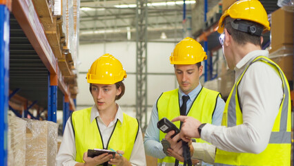 Teamwork of workers working in large warehouse retail store industry.Rack of stock storage. Interior of cargo in ecommerce and logistic concept. Depot. People lifestyle. Shipment service for container