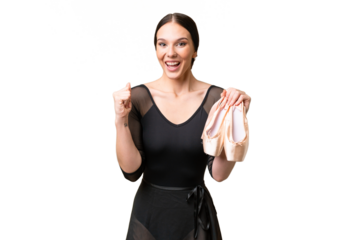 Young caucasian woman practicing ballet over isolated background celebrating a victory in winner position