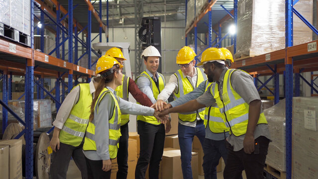 Teamwork group of multi ethnic workers working in large warehouse retail store industry factory. Stock storage. Cargo in ecommerce and logistic concept. Depot. People lifestyle. Shipment service.