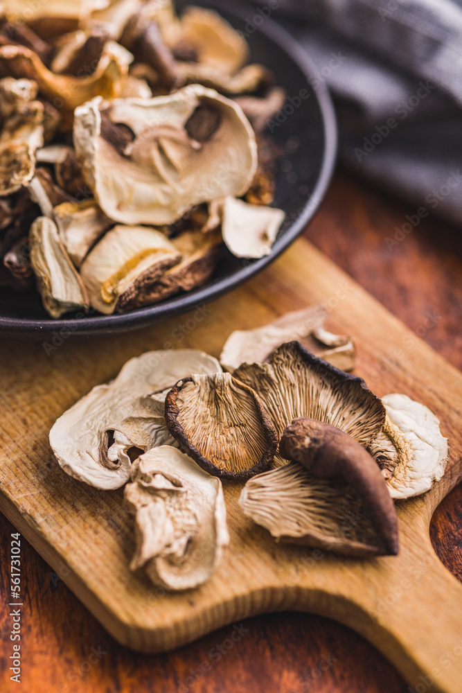 Wall mural various sliced dried mushrooms on cutting board.