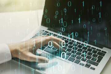 Creative abstract binary code hologram and hands typing on computer keyboard on background, AI and machine learning concept. Multiexposure