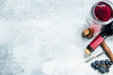 Wine background. Red wine with a grapes and a corkscrew.