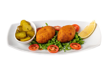 Kibbeh or icli kofte on a white background with pickles and salad
