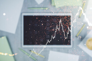 Double exposure of abstract creative financial chart with world map and digital tablet on background, top view, research and strategy concept
