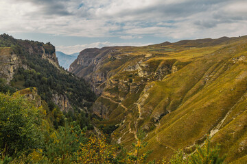 Snow-capped mountains and autumn fields. Beautiful mountain landscape in winter. Panoramic view, Dagestan, Russia.