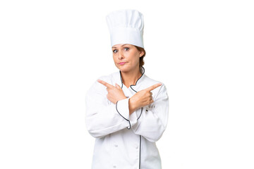 Middle-aged chef woman over isolated background pointing to the laterals having doubts