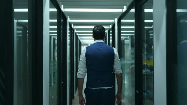 A businessman walks out of the conference room. With a dissatisfied expression of unsuccessfully presenting work and new projects to the management team for consideration in the conference room.