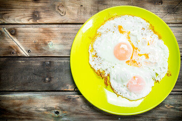 Fried eggs on a plate.