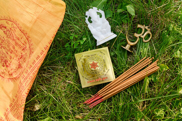 Model figurine Trishakti Yantra, Ganesha, incense sticks,on a herbal background.
