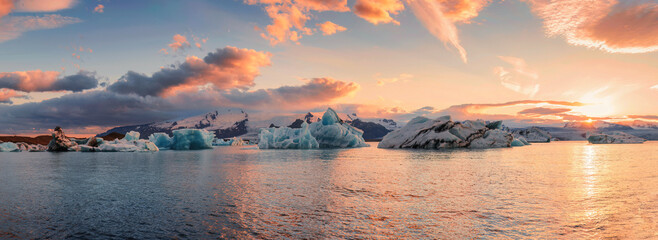 Scenery of Jokulsarlon glacier lagoon with blue iceberg melting and sunset sky on summer - Powered by Adobe