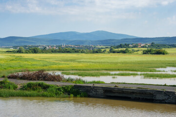 countryside lake in summer. mountainous rural area with village in the valley