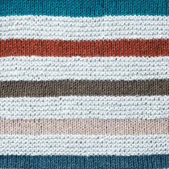 Knitted background. Texture of striped knitted cotton fabric close up.