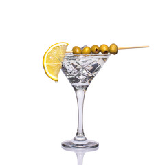 martini glass with lemon ice and olives on a bamboo stick, isolated on a white background