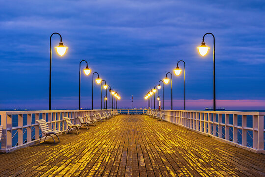 Poland, Pomerania, Gdynia, Illuminated Orlowo Pier at dawn