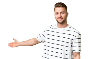 Young blonde caucasian man over isolated background extending hands to the side for inviting to come