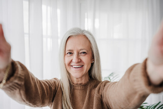 Smiling Mature Woman Taking Selfie At Home