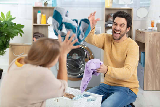 Happy Couple Having Fun Doing Laundry Together