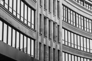 grayscale shot of background of an old  building with a lot of windows