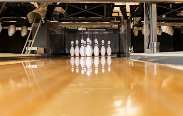 Bowling pins arranged on track at alley