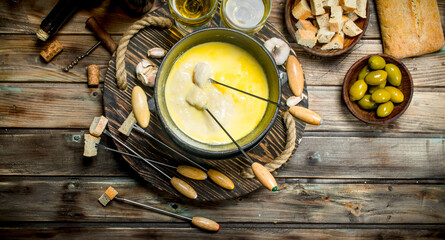 Delicious fondue cheese with olives and white wine.