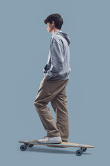 Teenager posing with a skateboard © stokkete