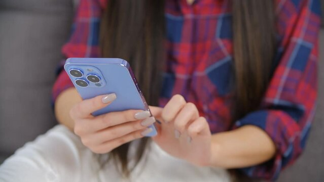 Girl swiping to the left in mobile app on smartphone. Young female person browsing modern cellphone application in closeup video with zoom in effect
